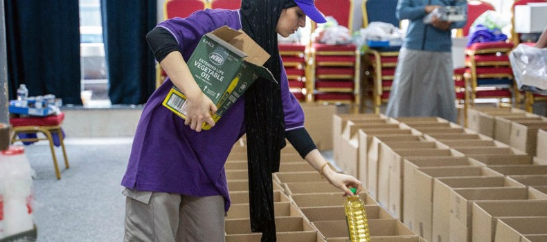 Ramadan Daily Sadaqah stacks of food parcels prepared for distribution.